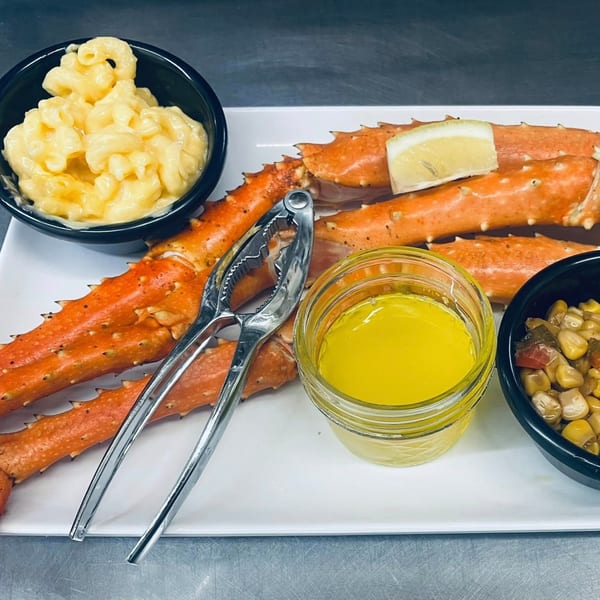 Heintzelman's BBQ Pit king crab legs with mac and cheese, corn, melted butter, and a lemon.