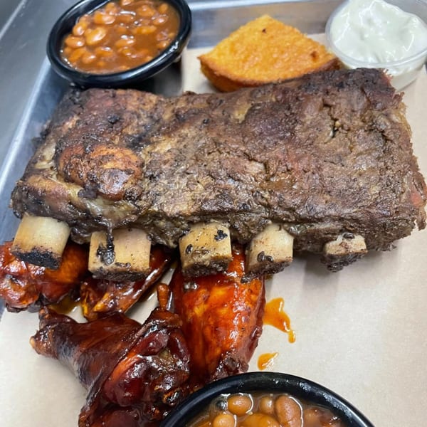 Heintzelman's BBQ Pit ribs and chicken wings with baked beans, cornbread, and coleslaw.